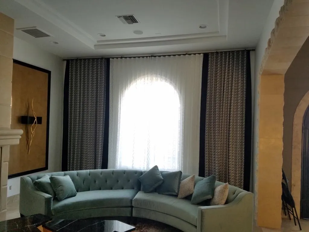 Living room with arched-window sheers and banded side panels