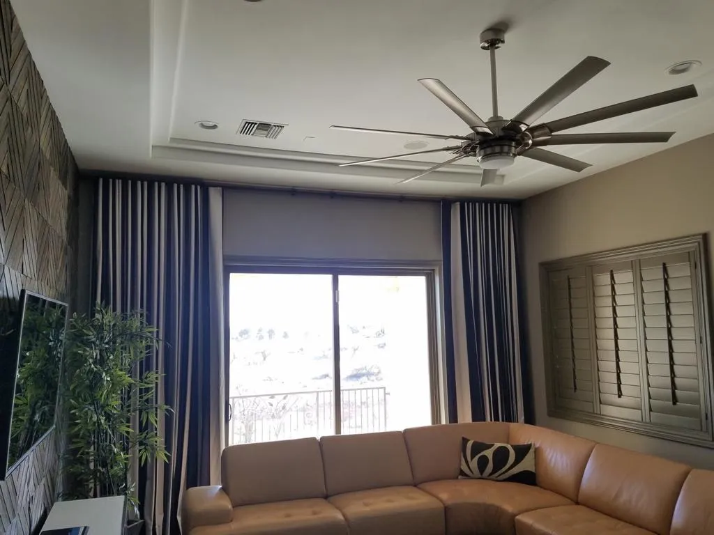 Living room drapery with banded panels beside plantation shutters