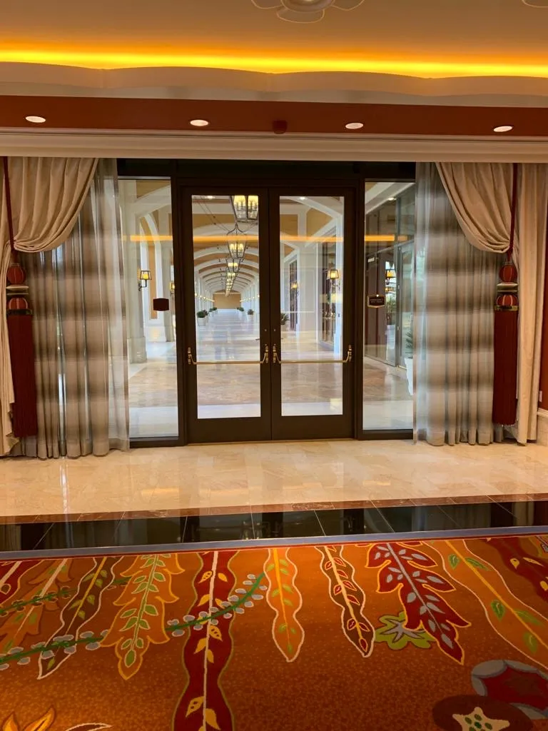 Wynn Design sheer drapery with tieback panels framing glass doors