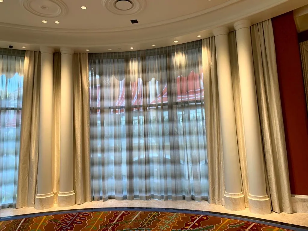 Wynn Design sheer drapery across a curved window wall