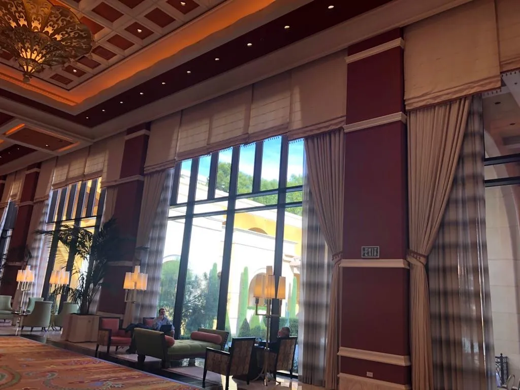 Wynn Design sheers and roman shades in a resort lounge