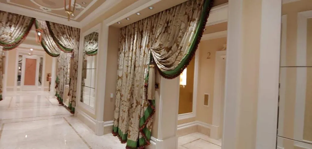 Wynn Design swag drapery with tieback panels along a hallway